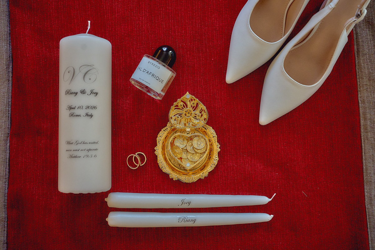 Details of wedding preparations: bridal shoes, perfume, wedding rings, unity candle