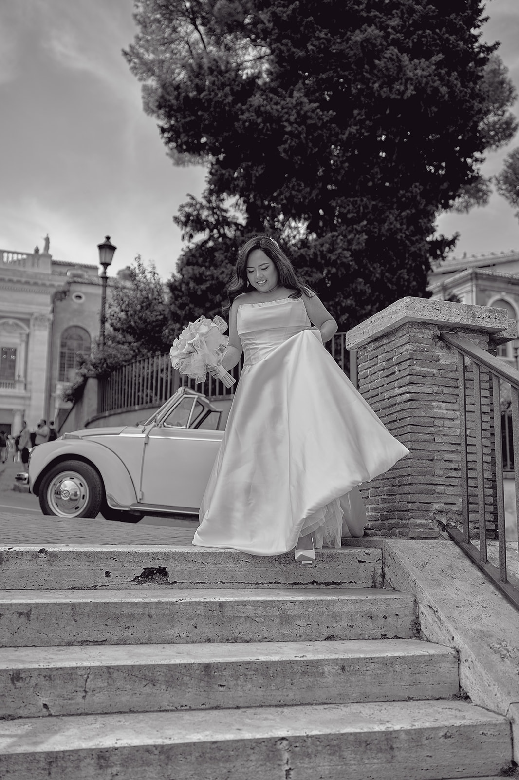 Bride walking down steps in Rome