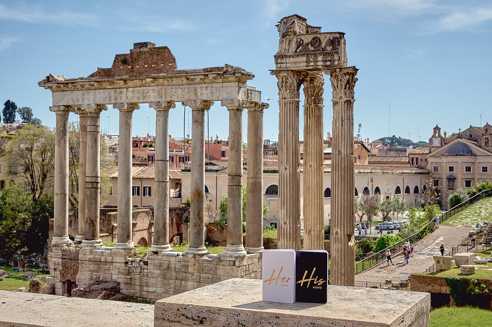 His and her vows booklets with the Roman Forum in the background
