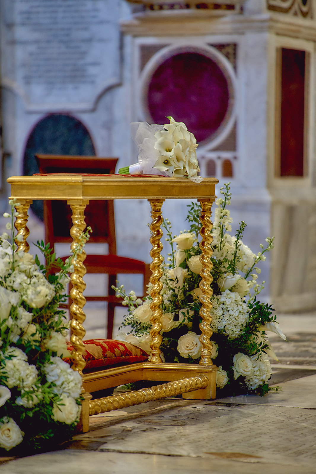Detail of bride and groom pew with flower arrangements