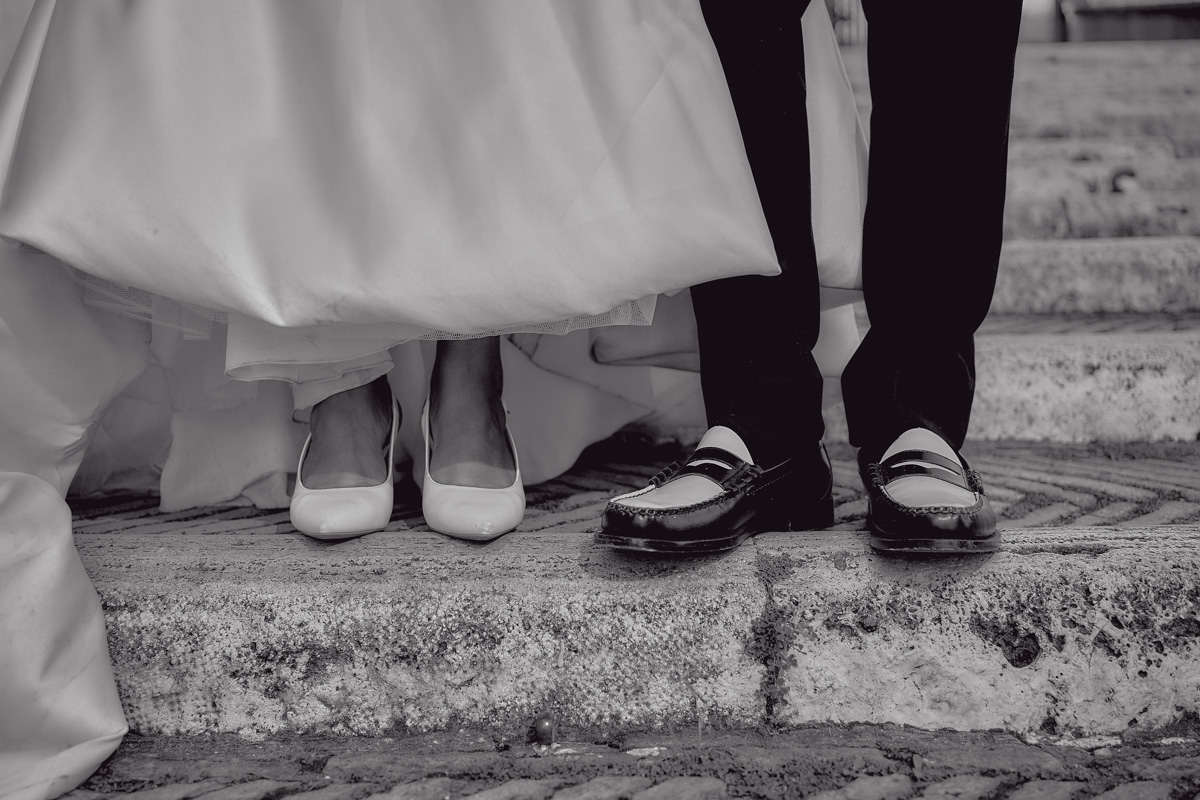 Detail of bride's shoes and groom's shoes