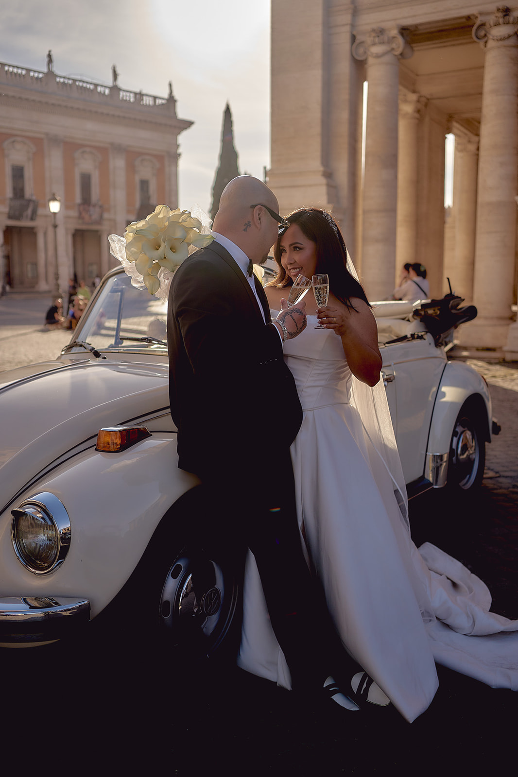 Portrait of newlyweds toasting near vintage Beetle