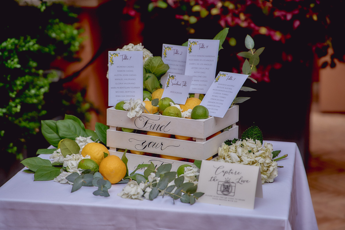 Seating chart made of a white wooden crate full of lemons and limes