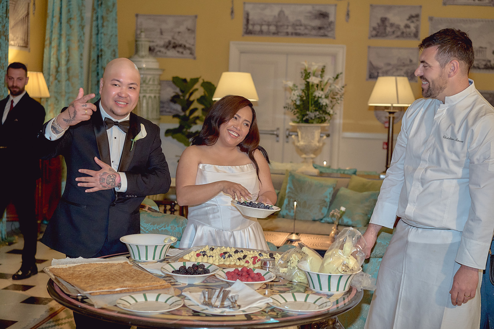 Newlyweds decorating the wedding cake