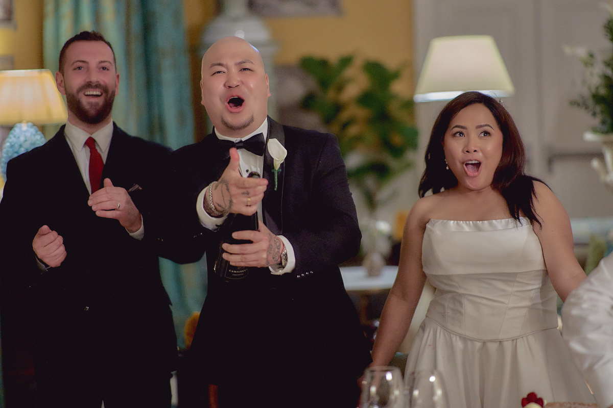 Groom opening prosecco bottle