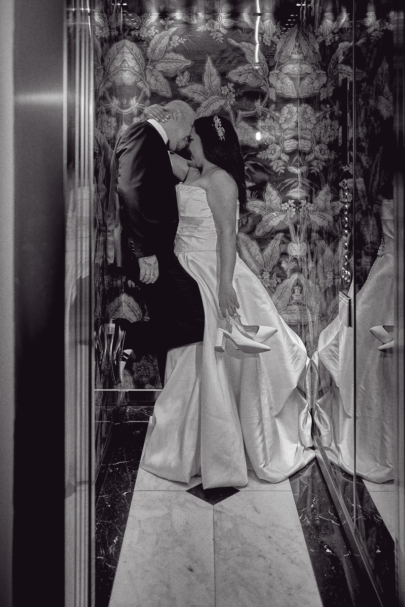 Romantic pose of newlyweds in a lift at Hotel De La Ville, Rome